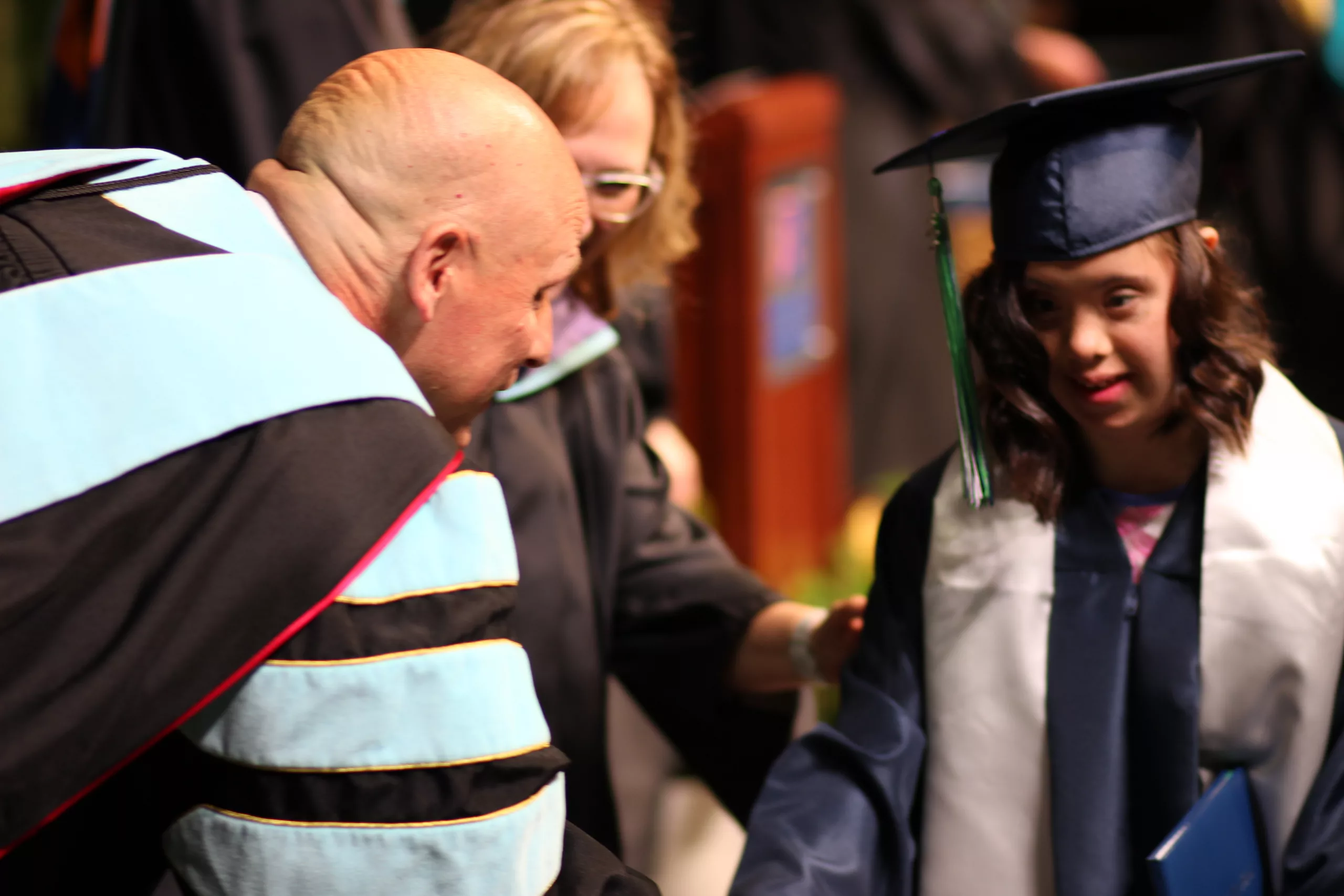 Superintendent shaking hands with student graduating